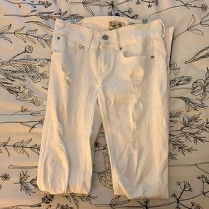 White ripped skinny jeans with navy strip on bottom